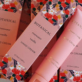 Botanical hand cream with floral packaging on a matching background