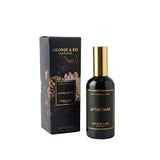 George & Edi Wanka After Dark Perfumed Linen Mist in a black bottle with a gold cap, shown next to its black floral-patterned packaging box on a white background.