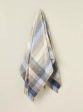Plaid blanket with fringes on a beige background